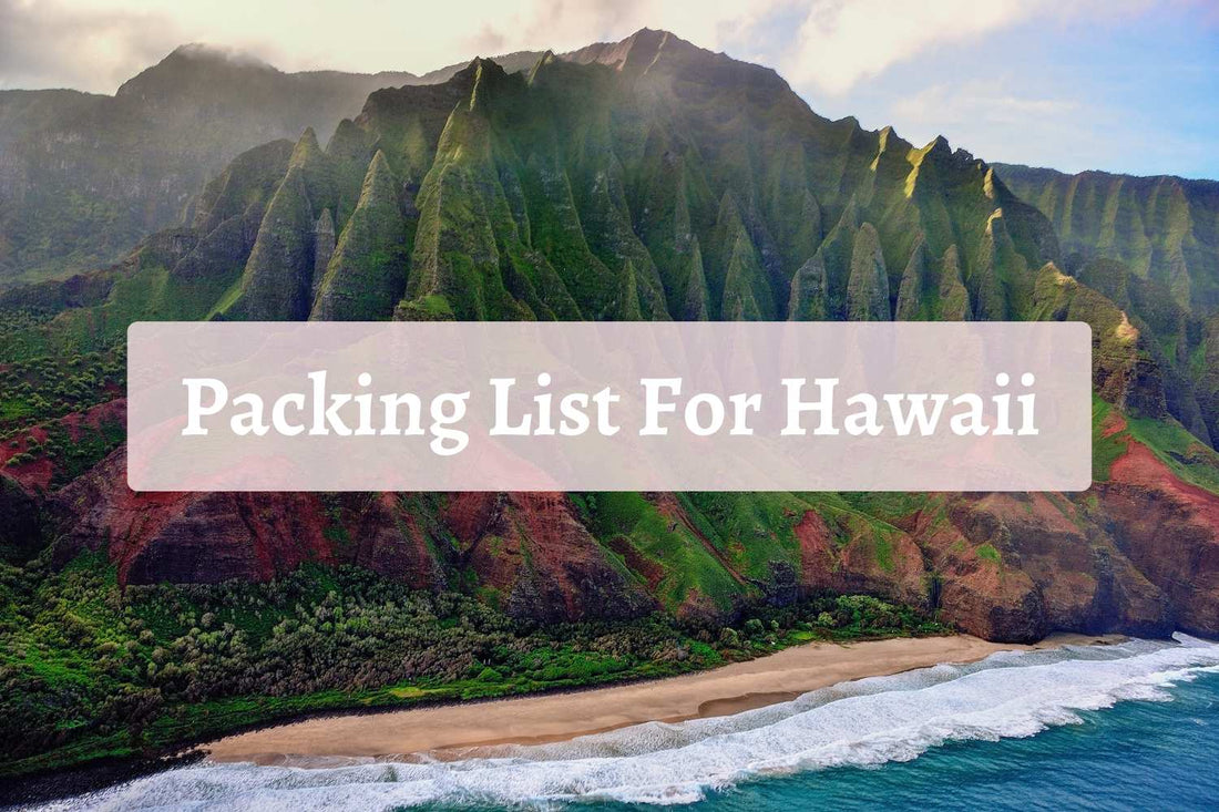 Aerial view of the lush green cliffs and sandy beach along Hawaii’s Nā Pali Coast, with the words “Packing List For Hawaii” overlaid—perfect visual for a tropical travel guide.